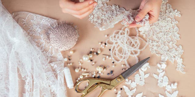 Bridal wear designer works with lace cuttings.