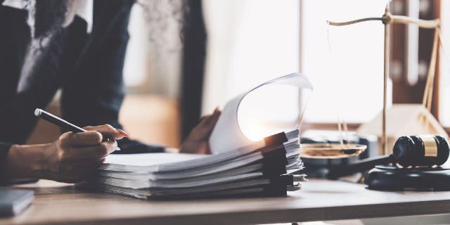 Lawyer reviews legal codes in book