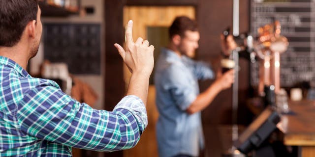Man tries to get bartender's attention