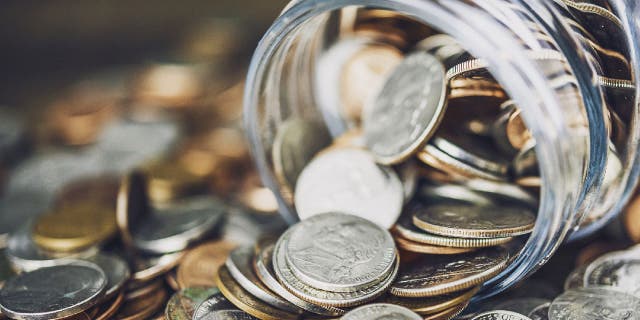 Glass jar filled with coins