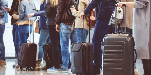 Passengers line up to get on plane