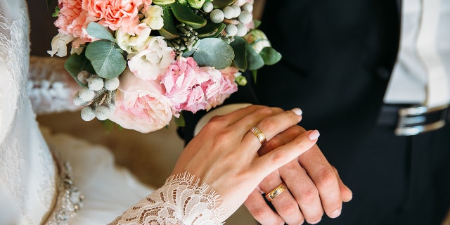 bride and groom holding hands
