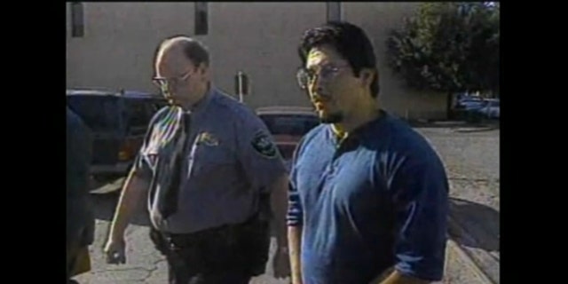 Raul Meza walking in handcuffs in the 1980s
