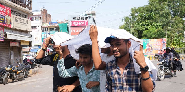 Indians use cloth to protect themselves from sun