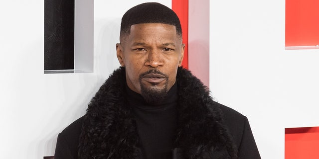 Jamie Foxx poses at a red carpet event