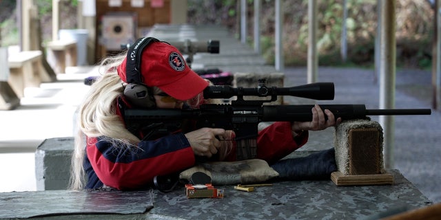 Firearms instructor Jane Milhans shoots a modern sporting rifle at a range in Washington state