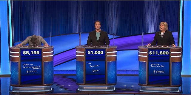 Three contestants in playing Jeopardy.