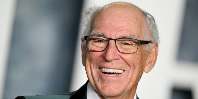 Jimmy Buffett poses in a tux at a red carpet event.