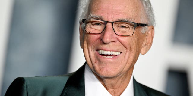 Jimmy Buffett poses in a tux at a red carpet event.