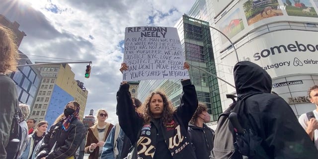 Protestors hold signs during Jodan Neely protest in New York City