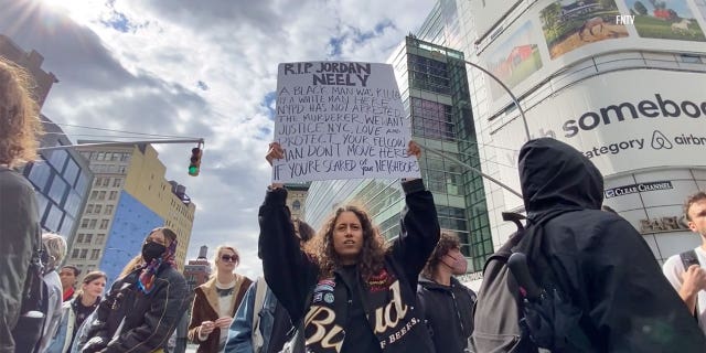 Protestors hold signs during Jodan Neely protest in New York City