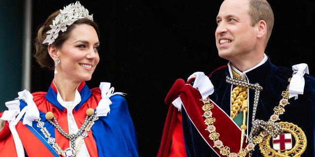 Kate Middleton wearing a fancy headpiece standing next to Prince William during the coronation