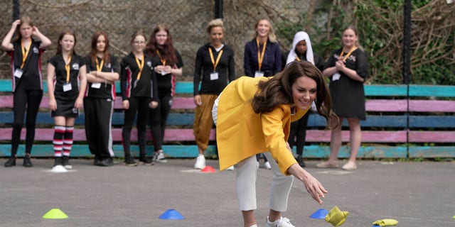 Kate Middleton playing a game with bean bags