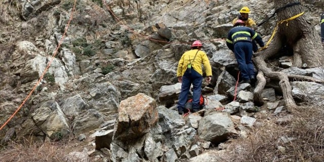 rescue personnel on rocks