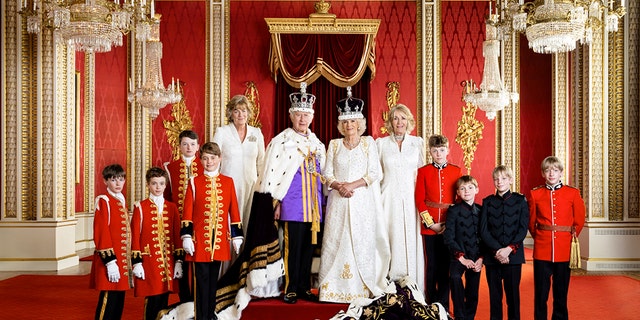 King Charles III, Queen Camilla center flanked by royal pages