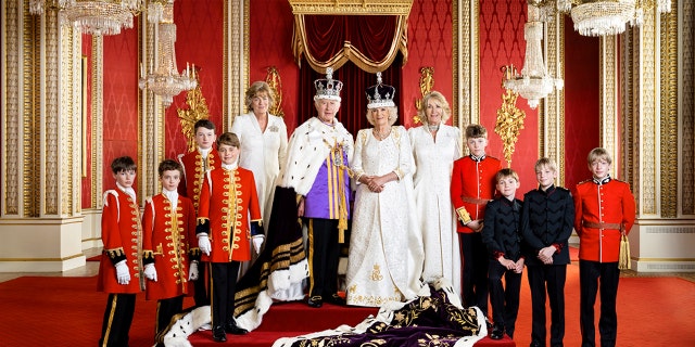 King Charles III, Queen Camilla center flanked by royal pages