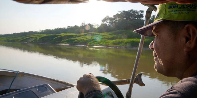 The man maneuvers the boat in Brazil