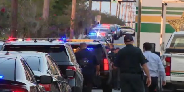 police and vehicles at scene of shooting