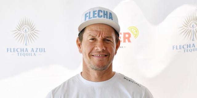 Mark Wahlberg in a white t-shirt and hat