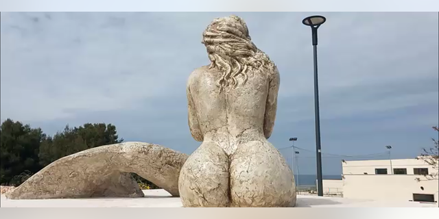 Italian mermaid statue seen from the back