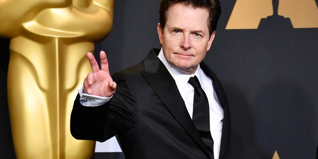 Michael J Fox held up a peace sign on the red carpet at the Oscars in 2017.