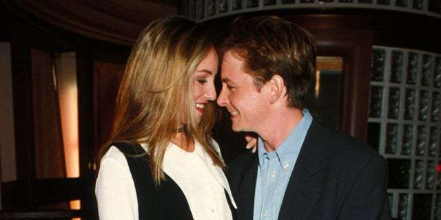Michael J. Fox and Tracy Pollen smile at each other and stand close in sweet photo.