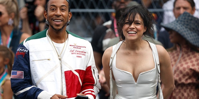 Michelle Rodriguez wears white corset top at Formula 1 race with Ludacris