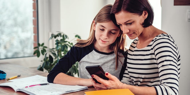 Mother and daughter looking at phone