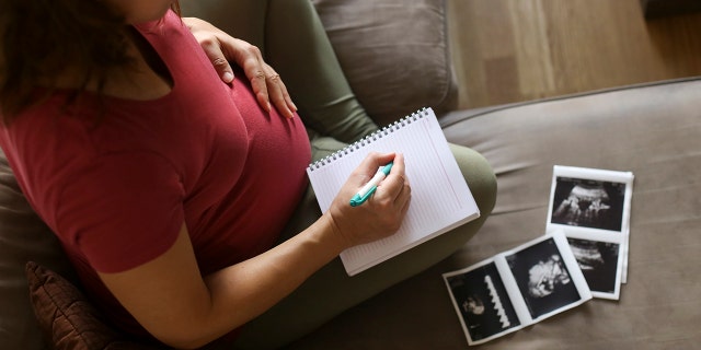 mom writing baby name