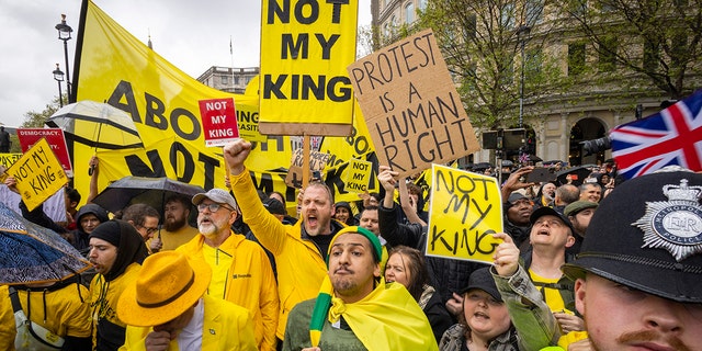 Protesters holding signs that say "Not my king."