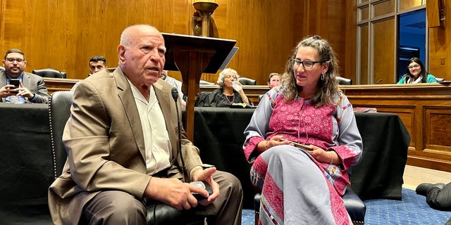 Two Palestinian Americans, a male and female, sit and speak in a Senate hearing room