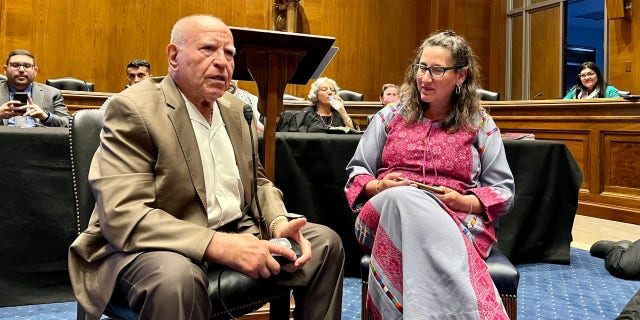 Two Palestinian Americans, a male and female, sit and speak in a Senate hearing room