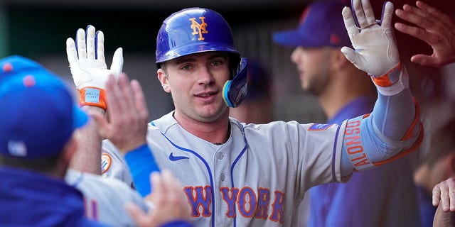 Pete Alonso high-fiving in dugout