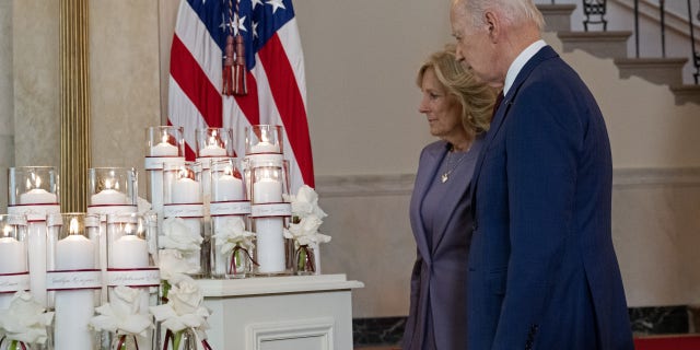 President Joe Biden and First Lady Jill Biden stand by a memorial for the 21 victims of the 2022 mass shooting in Uvalde, Texas, at the White House