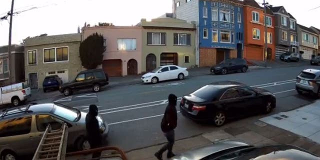 Suspects walking down street in all black