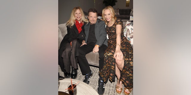 Meg Ryan smiling with Michael J. Fox and Tracy Pollan