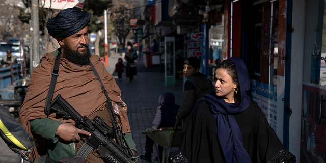 Taliban fighter and Afghan woman