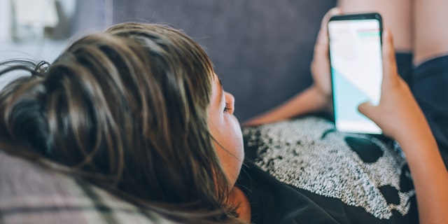 Teen scrolling on phone