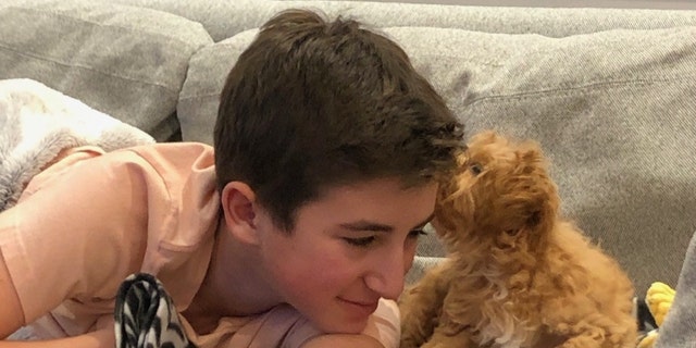 Nate Bronstein plays with a puppy