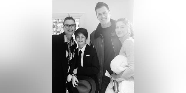 In a black and white photo, Tom Brady and his then wife Gisele Bündchen pose with his son Jack, and his mom Bridget Moynahan 