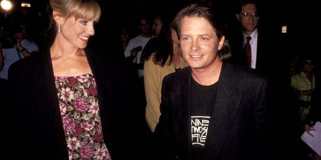 Michael J. Fox holds hands with wife Tracy Pollan in 1991.