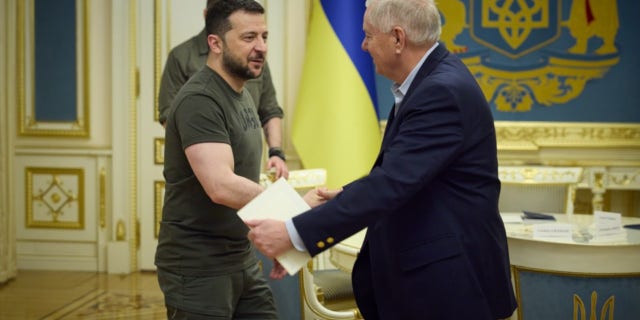 Ukrainian President Volodymyr Zelenskyy shakes hands with Sen. Lindsey Graham