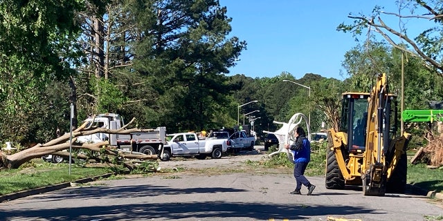 crews cleaning debris from street