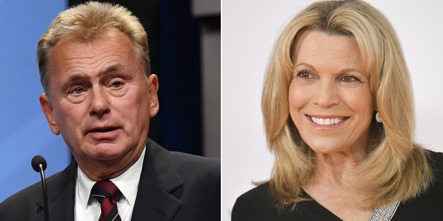 Pat Sajak looks perplexed in a black suit and red and black striped tie speaking behind a podium split Vanna White in black smiles and looks off to her right on the carpet