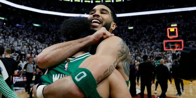 Derrick White and Jayson Tatum embrace