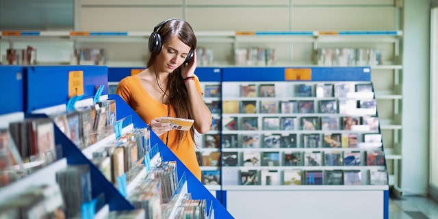 girl listening to music in cd store