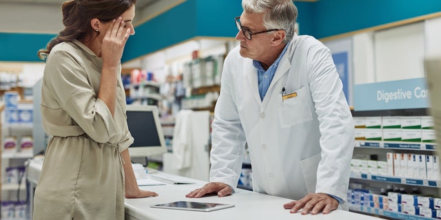 Sick woman at the pharmacy