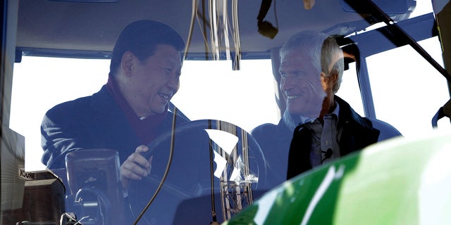 Xi Jinping sits in a tractor with an American farmer