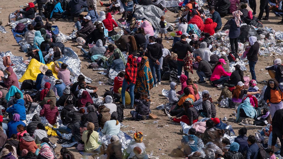 Migrants wait for processing