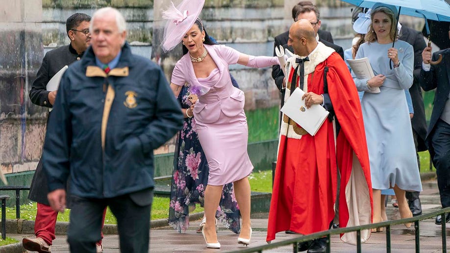 Katy Perry, stumbles as she leaves Westminster Abbe